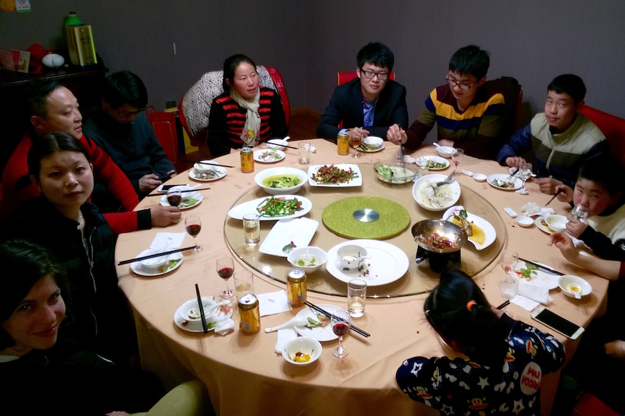 the family sitting at a round table in the restaurant