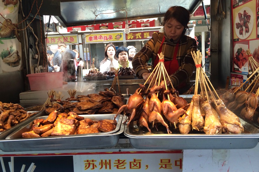 food market with fried birds (probably chicken and pigeons)