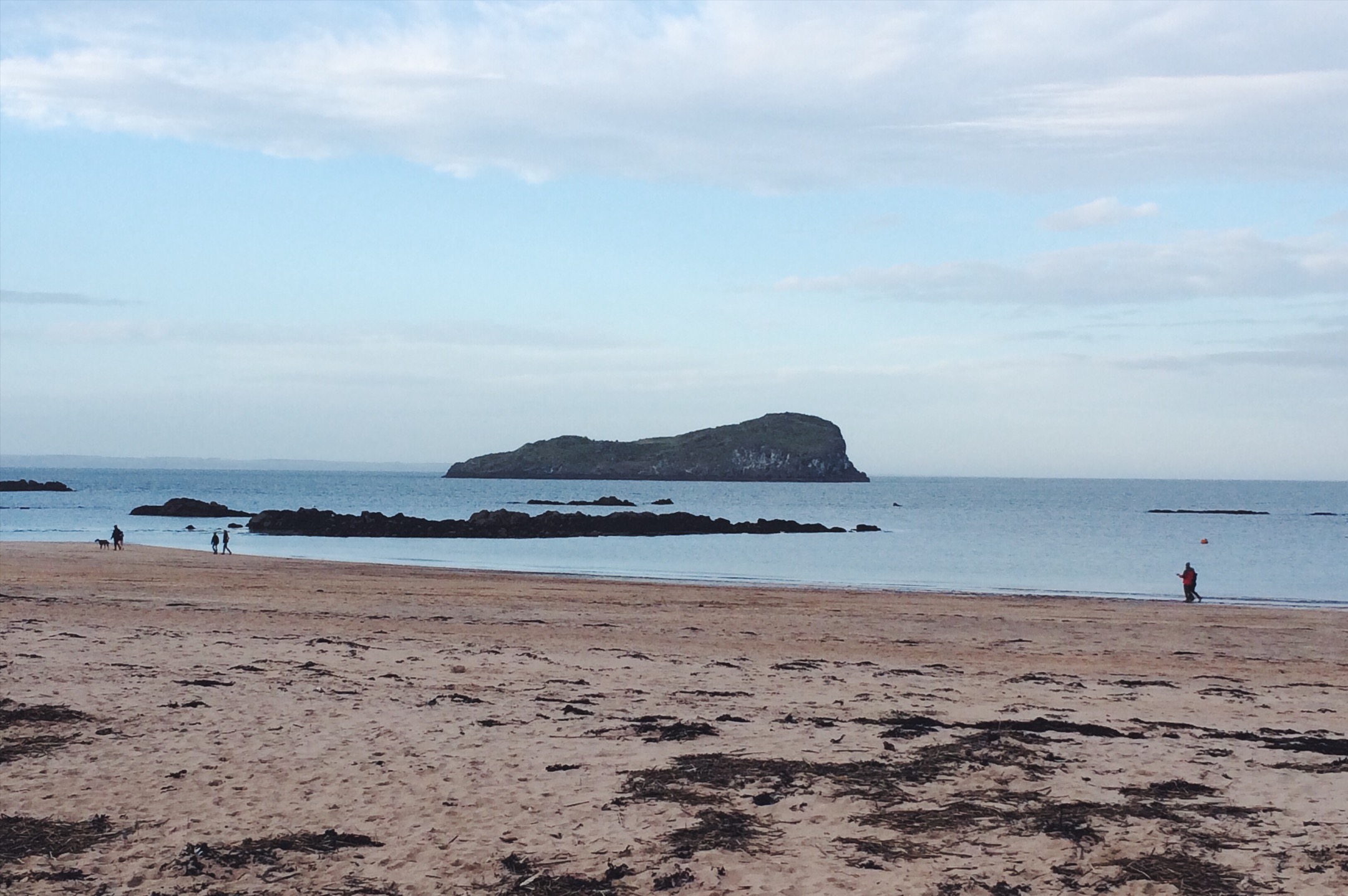 People walking on the beach in coats